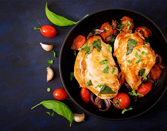 Image of chicken breasts simmering in tomato sauce